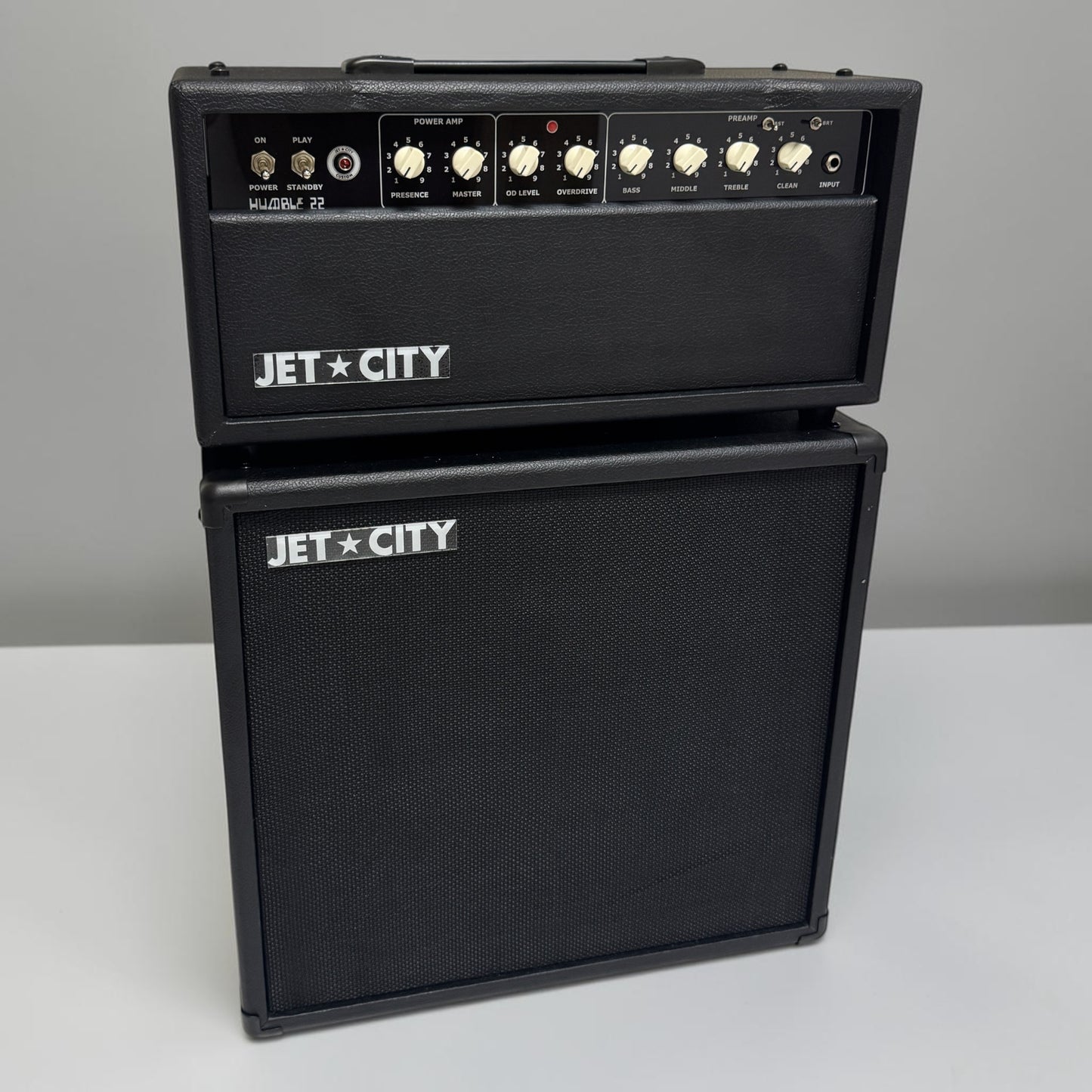 A stacked black JET CITY Humble 22 and matching speaker cabinet, photographed against a plain light gray background.